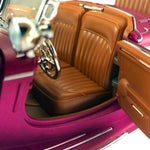 Close-up of a toy car with brown interior and pink exterior