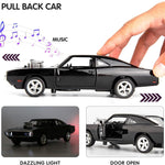 Black toy car with music, light effects, and open door feature, held by a hand.